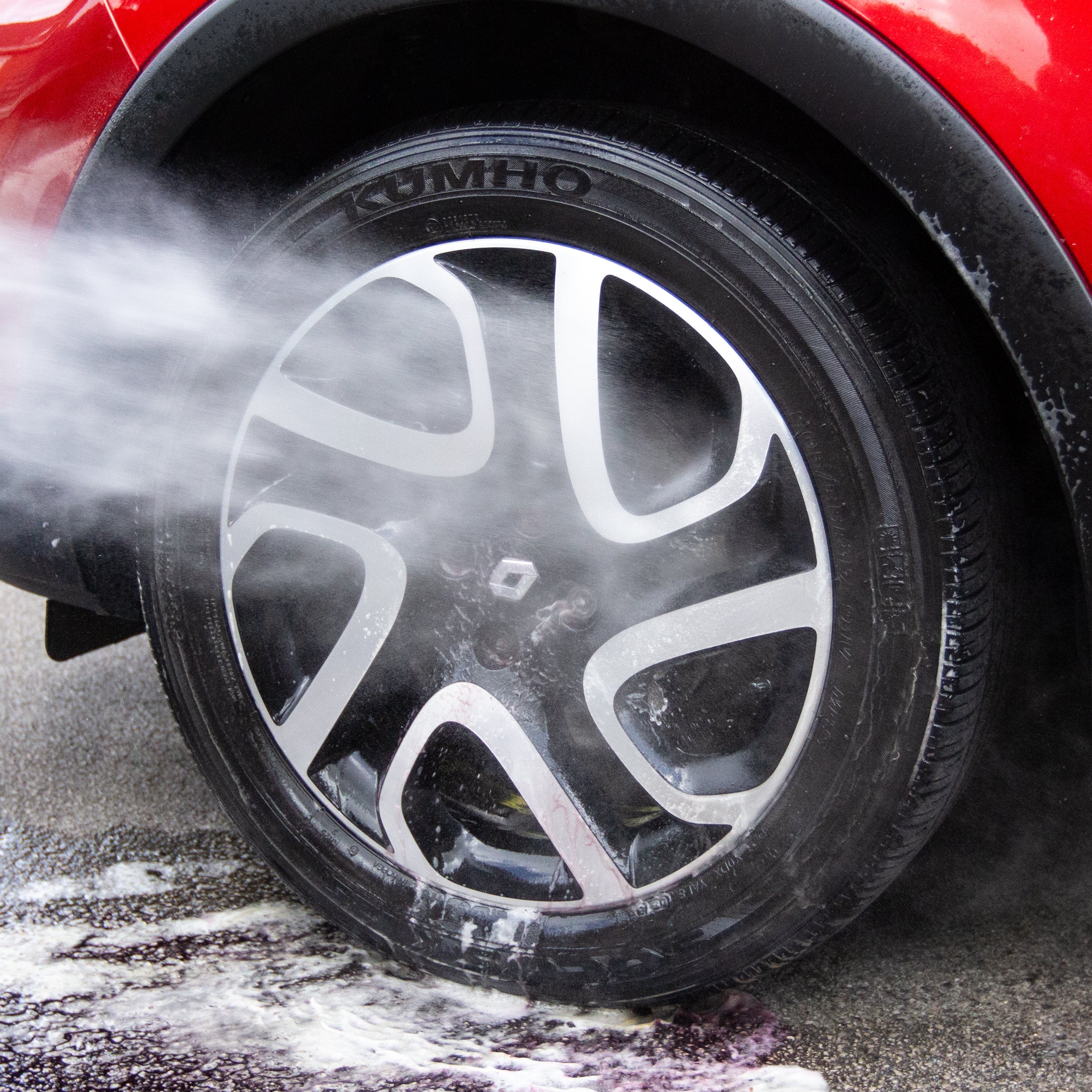 Gloss Fuel Iron Fallout Remover being rinsed off with a pressure washer