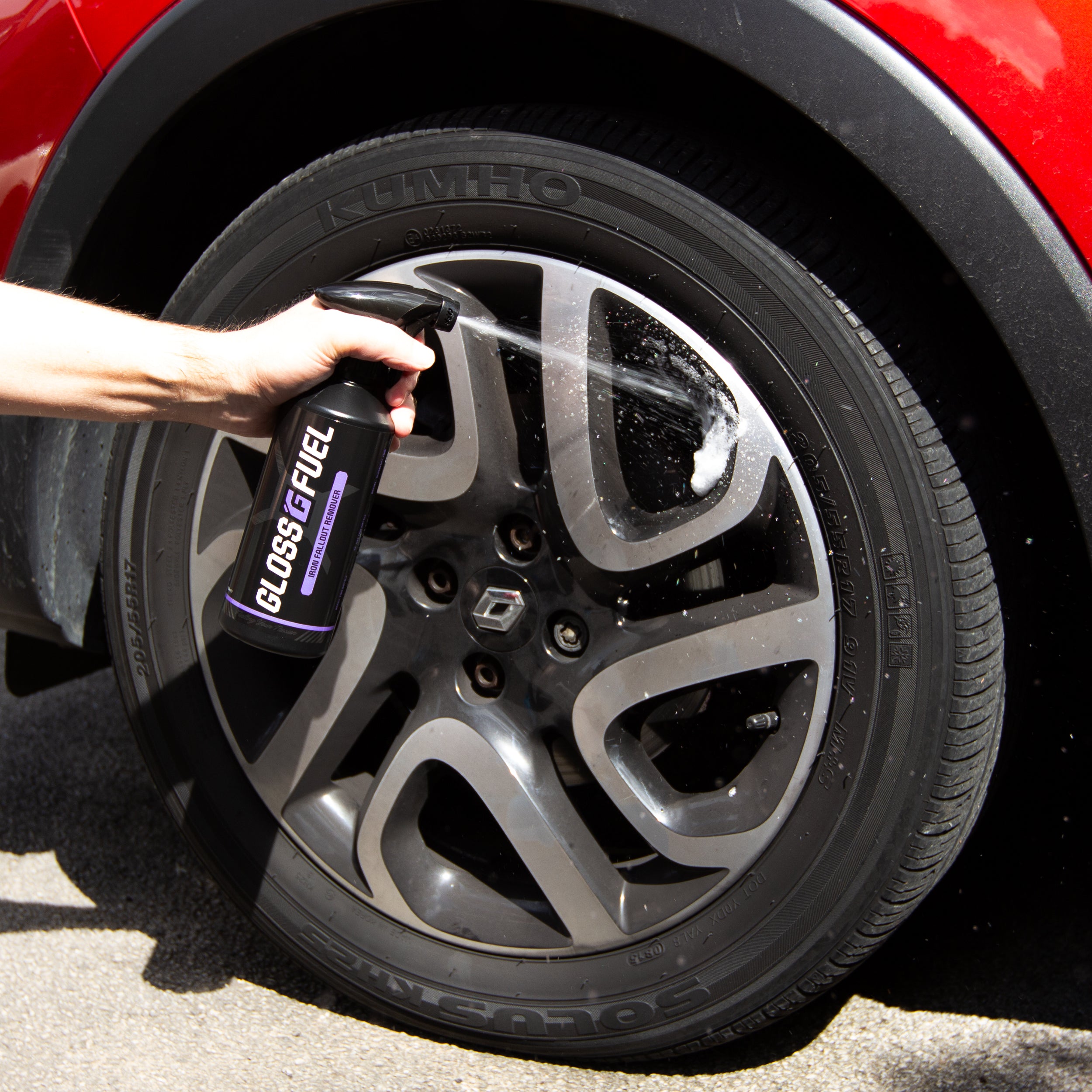 Gloss Fuel Iron Fallout Remover being sprayed onto a dirty alloy wheel