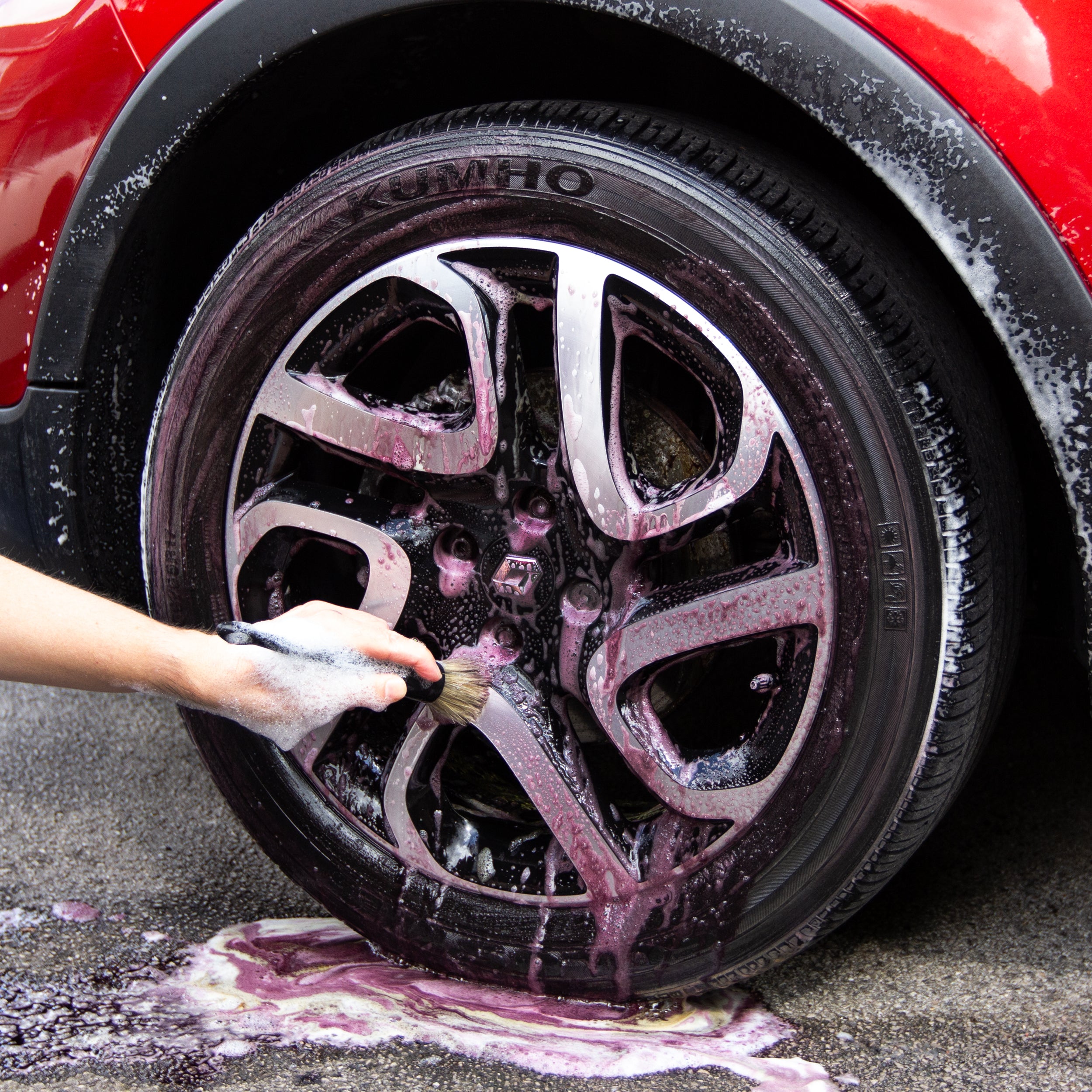 Gloss Fuel Iron Fallout Remover being agitated with a hogs hair detailing brush.