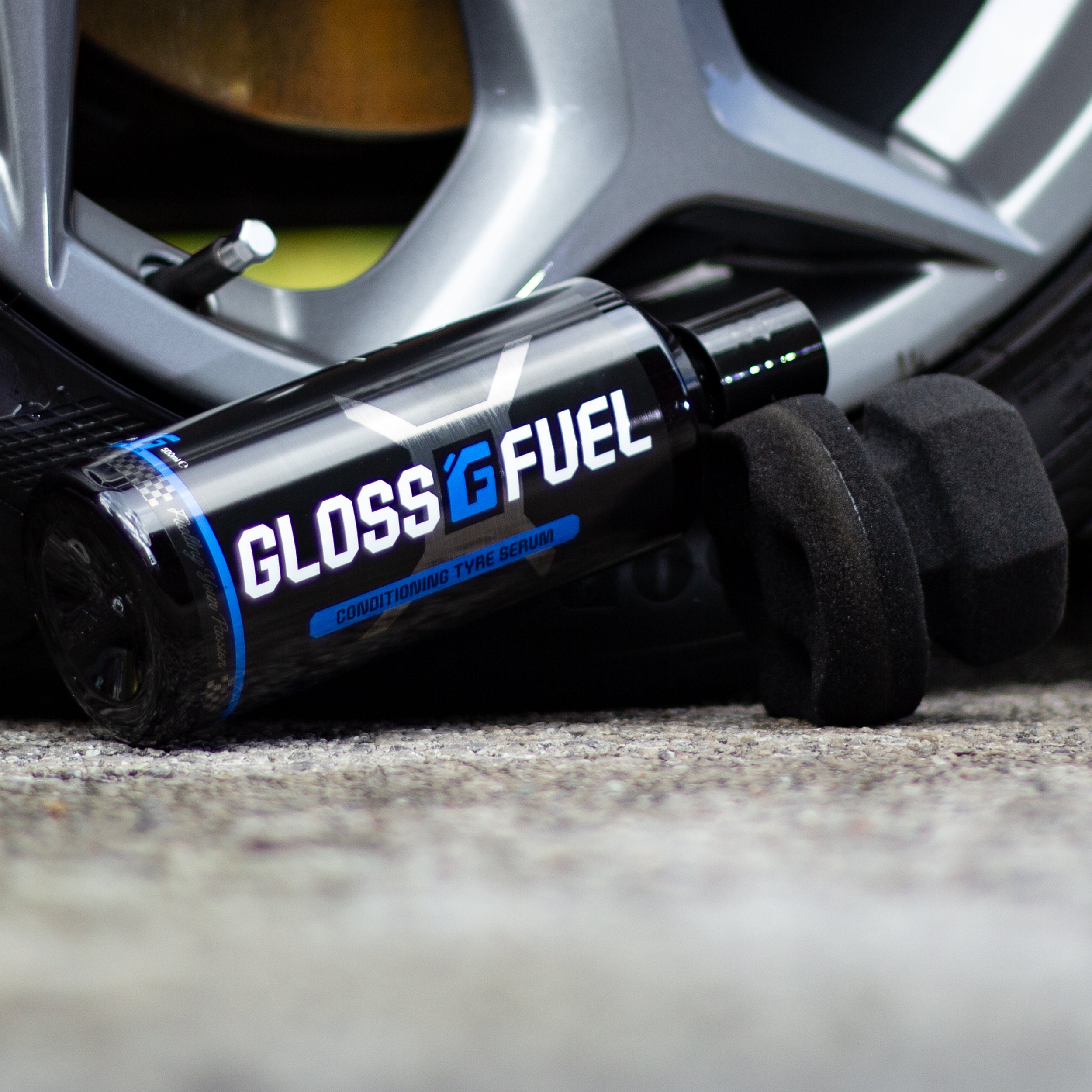 Gloss Fuel Conditioning Tyre Serum Bottle next to a Ford Focus ST Alloy Wheel